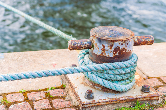 Mooring rope wound around a mooring bollard on the embankment in Stockholm.Sweden