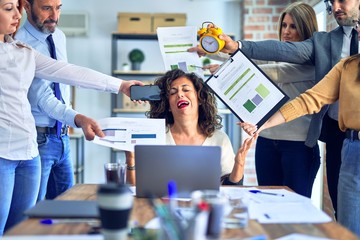Group of business workers working together. Partners stressing one of them at the office