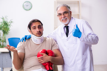 Young face injured man visiting experienced male doctor traumato