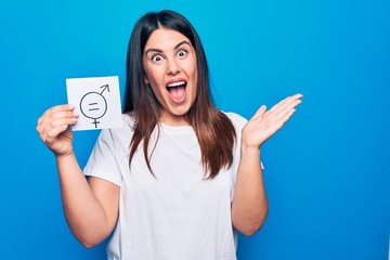 Young beautiful woman asking for sex discrimination holding paper with gender equality concept...