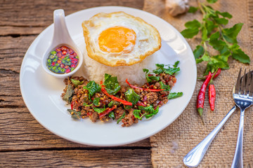 Thai Food Rice topped with egg and stir-fried beef and basil, famous street food in Thailand, fast food, soft focus