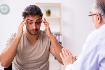 Young face injured man visiting experienced male doctor traumato