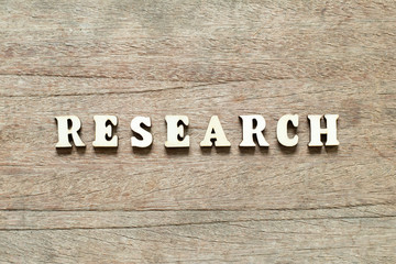 Letter block in word research on wood background