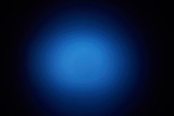Blurred volumetric oval cloud of blue light against a dark background