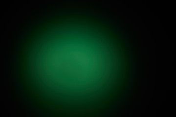 Blurred volumetric oval cloud of green light against a dark background