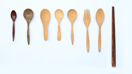 Set wooden spoon, fork and chopstick isolated over white background. Top view