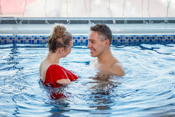 Man and woman leisure in the pool.