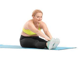 Woman with excess weight training on white background