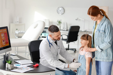 Fototapeta premium Woman with her little daughter visiting gastroenterologist in clinic