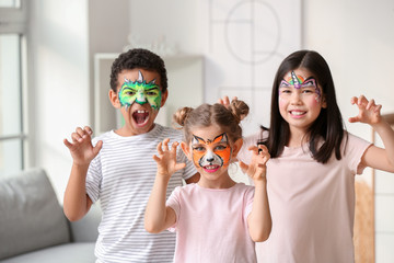 Funny little children with face painting at home