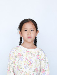 Peaceful asian little girl looking at camera over white background