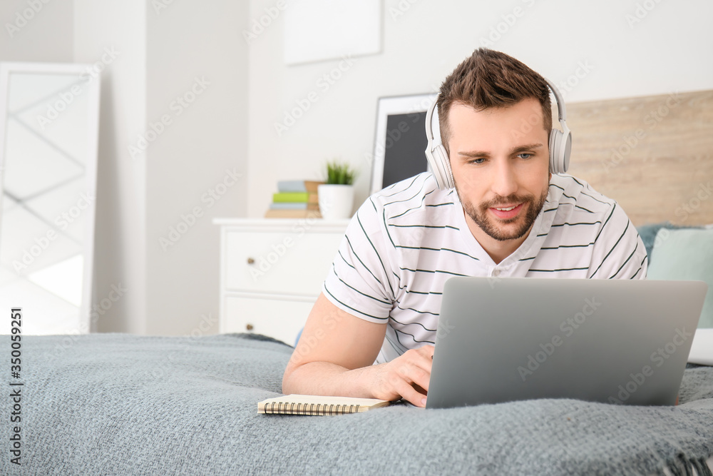 Sticker Young man with laptop working at home