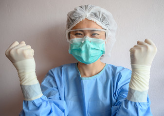 Nurse wearing scrubs with mask for protect virus before surgery operation. In coronavirus pandemic outbreak we should support and encourage healthcare worker by stay home and listen to medical advice.