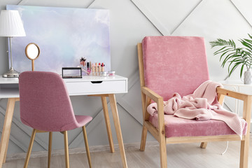 Interior of modern room with comfortable armchair and dressing table