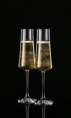 Glasses of champagne on dark background