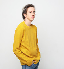 young man with emotions on his face a grey background