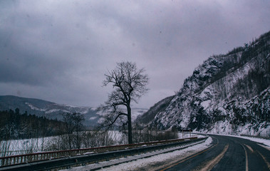 Fototapeta premium Snowfall on the road on the pass