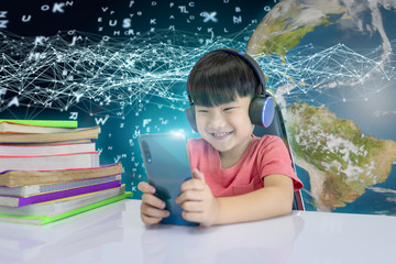 Cute boy watching smartphone With Large stack of books on beside. Distance education concept....