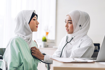 Muslim asian woman doctor service help support discussing and consulting hold stethoscope exam muslim woman patient and check up information at meeting health medical care concept in hospital