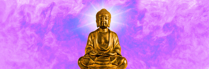 A small, golden replica statue of The Buddha against a smokey background