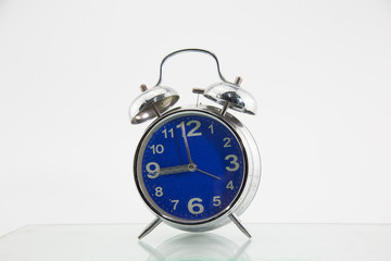 An alarm clock placed on a white background