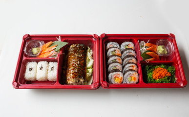 Japanese food put in a box placed on a white table