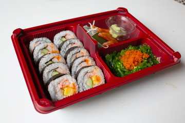 Japanese food put in a box placed on a white table