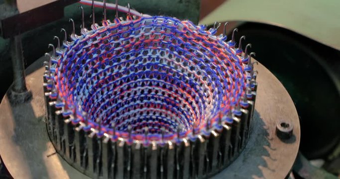 Knitting Loom manufacturing textile using colors, colorful rolls of thread
