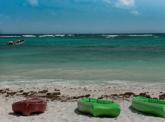 bright kayaks on the beach,  in a sunny day with blue sky