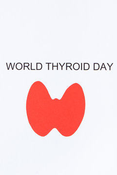 Red thyroid shape and inscription World Thyroid Day. Problems with thyroid concept