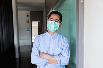 Fototapeta na wymiar A young businessman wearing masks prevent the spread of the Covid-19 virus while in office.