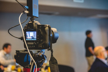 Professional photo camera recording a seminar with breakfast in a hotel salon