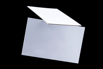 White triple business cards, floating on a black background, a mock-up