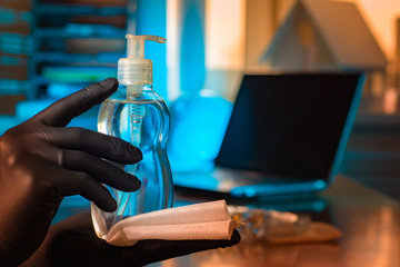 Antiseptic in the hands of man. Hand cleaning fluid. Hands of a man in gloves. Concept - office treatment by a sanitizer. Clearing rooms from bacteria. Concept - cleaning with an antiseptic.