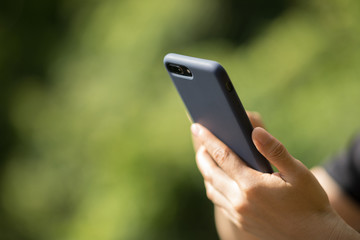 Hands using mobile phone taking picure in spring nature