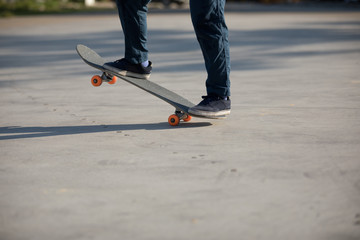 Fototapeta na wymiar Skateboarder skateboarding at morning outdoors
