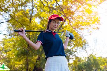 Portrait Asia woman play golf.She is playing golf on a sunny day. Hitting, scenery,
beautiful golf...