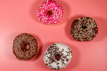 Tasty donuts on pink background. Top view