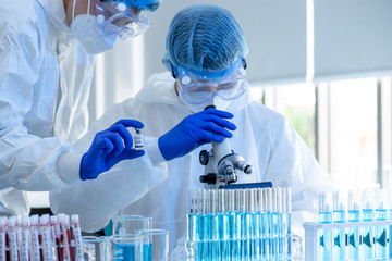Scientists are done research on vaccine in laboratory with test tubes on Covid19 Coronavirus type...