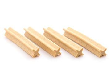 Close up X-Shape dental stick for puppy to reduce tartar build-up isolated on white