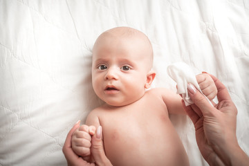 Mother Wiping Baby's Face. Concept Hygiene cleaning wipe, pure, clean