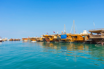 Traditional boats called Dhows are anchored in the port near Museum of Islamic Art Park,Doha, Qatar.