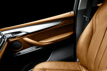 Brown leather interior of the luxury modern car. Perforated brown leather comfortable seats with...