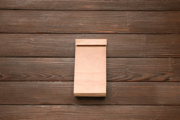 Paper bag on wooden background
