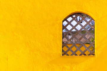 wooden window on a yellow wall in Rio de Janeiro.