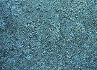 Rough and rough surface of natural stone painted in turquoise blue.