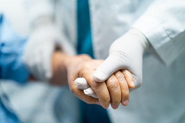 Doctor holding hands Asian senior or elderly old lady woman infected patient with love, care,...