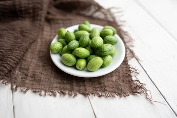 Freshly harvested cucamelons, Mexican sour gherkin pepquino or mouse melon. Sour grape size cucumbers. 