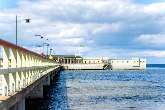 Malmo, sweden - 09 June 2019: Ribersborgs open-air bath, wooden pier in the Baltic Sea with walking people