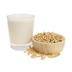 A glass of soy milk And soy beans in a wooden bowl isolated on white background.